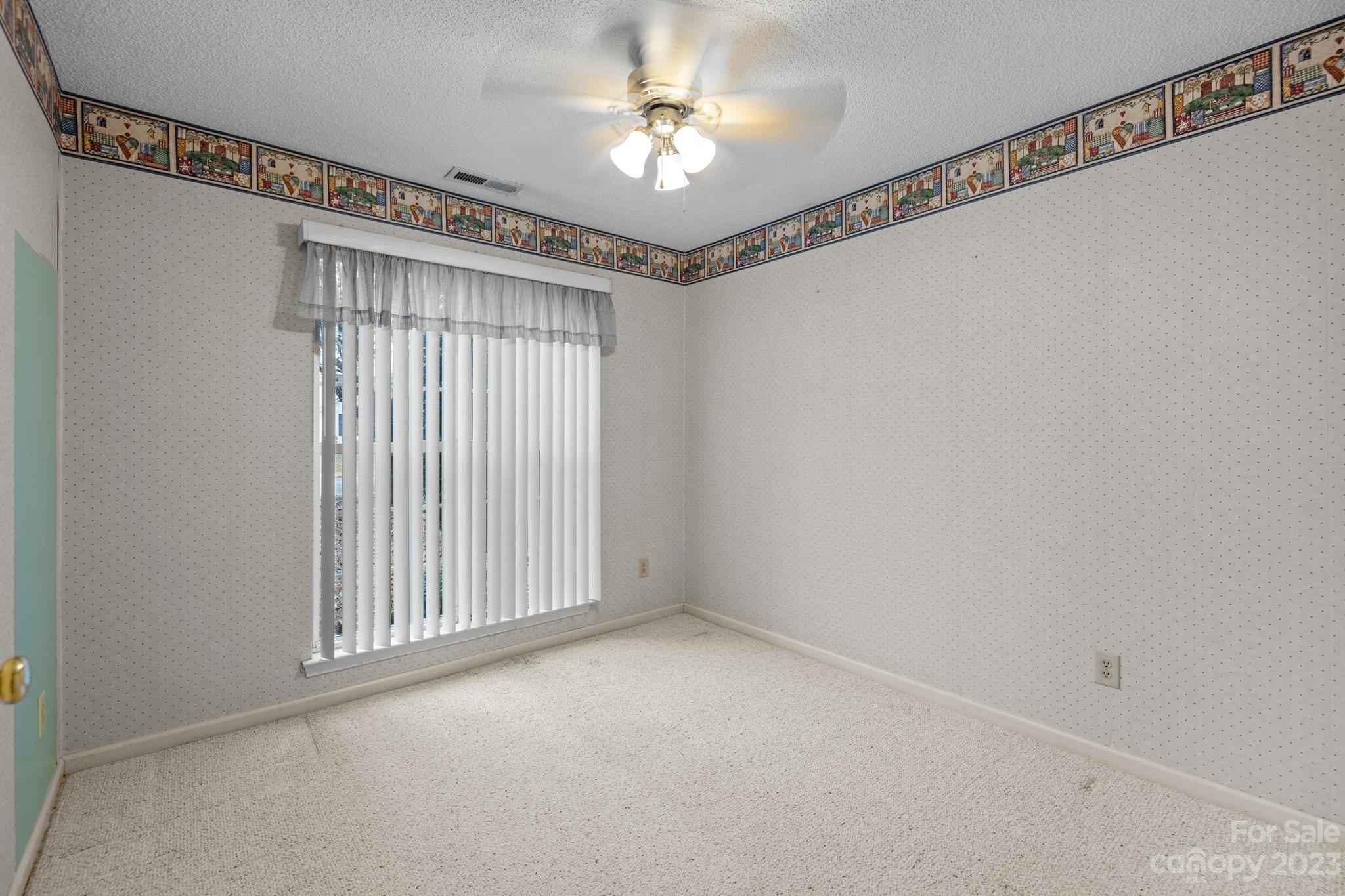 4445 Fawnbrook Avenue Southwest Concord, NC 28027 - Photo 18 of 27 a view of a livingroom with a ceiling fan and window