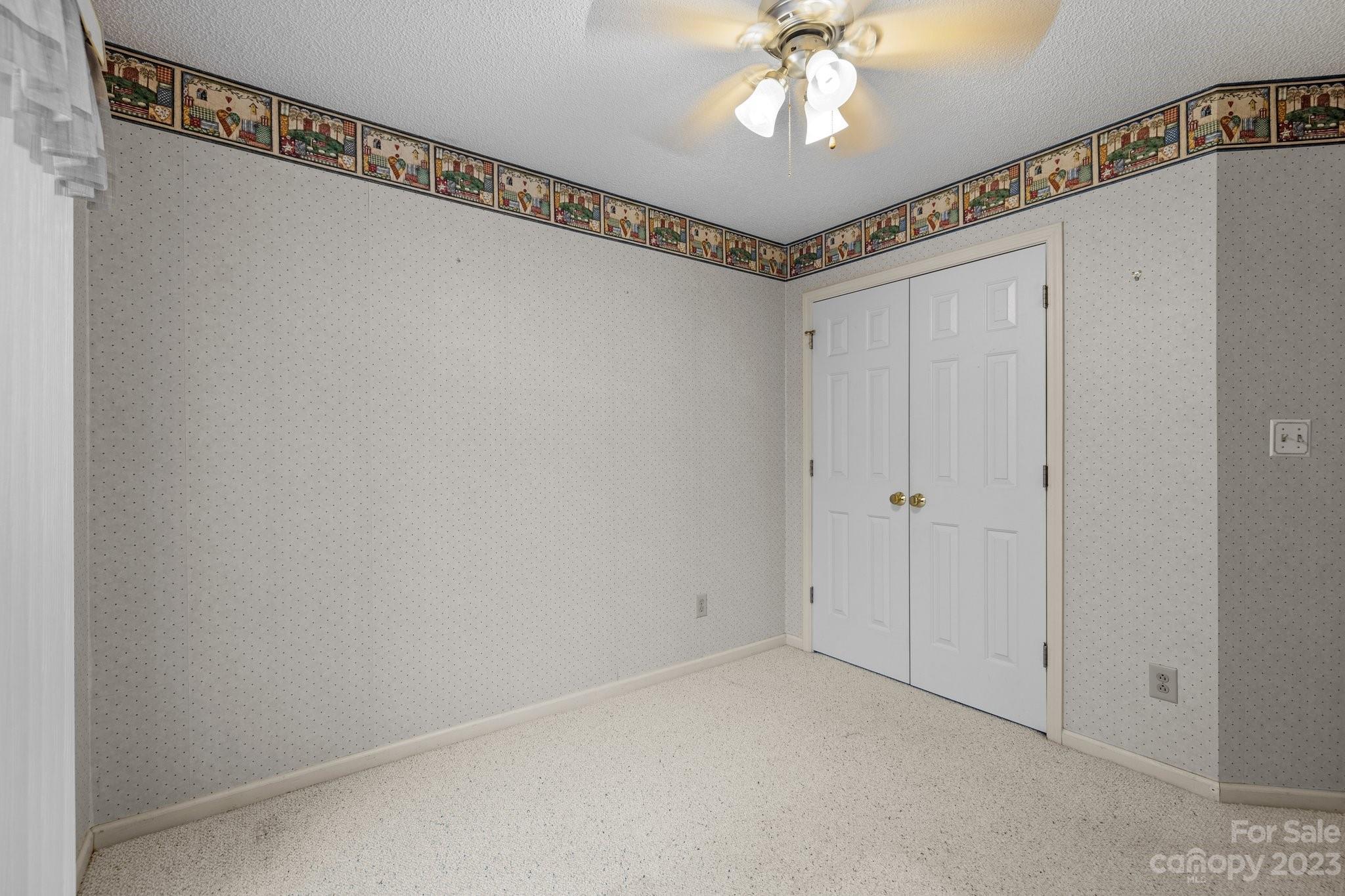4445 Fawnbrook Avenue Southwest Concord, NC 28027 - Photo 19 of 27 a view of a hallway with a chandelier fan