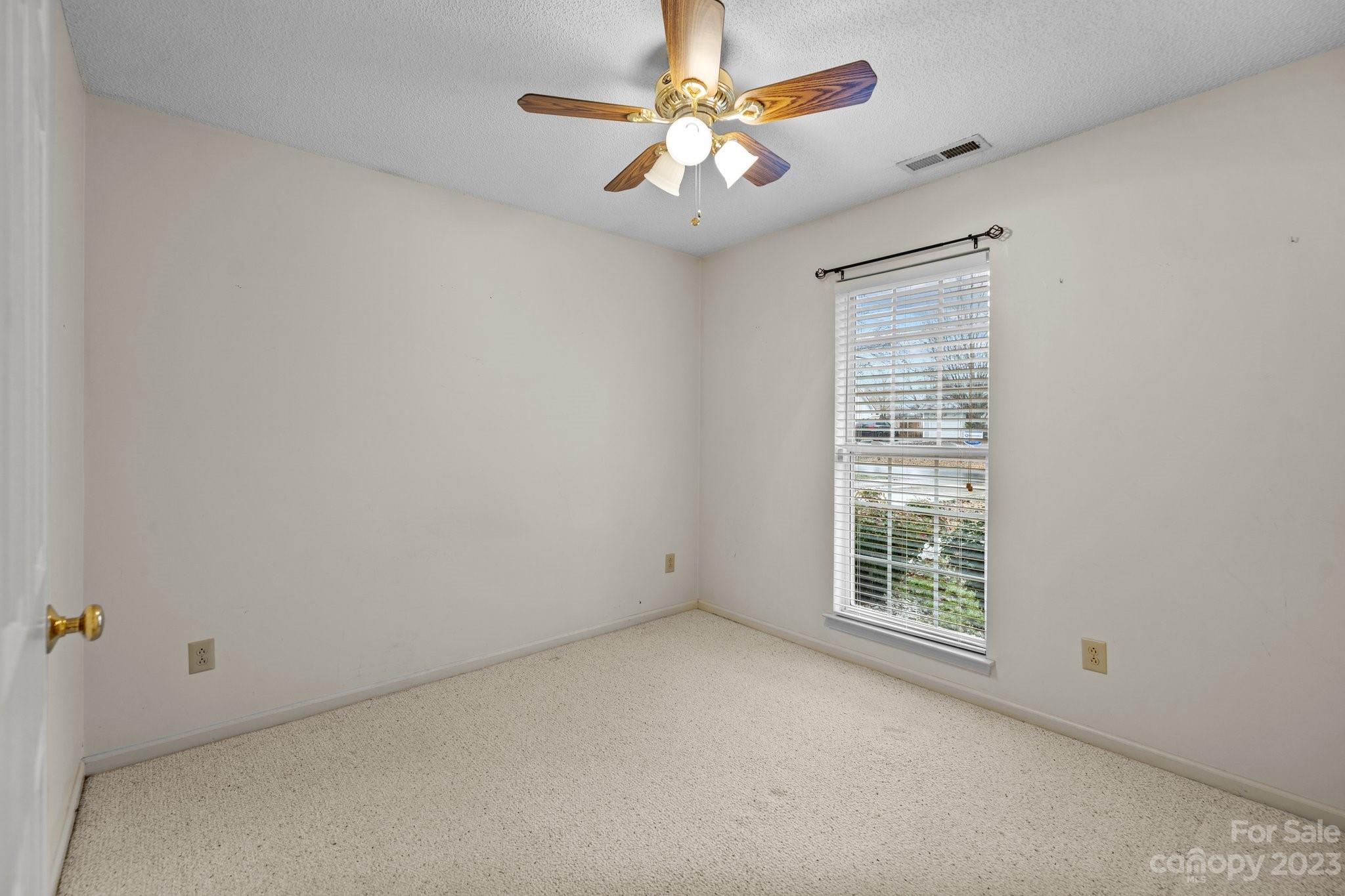 4445 Fawnbrook Avenue Southwest Concord, NC 28027 - Photo 20 of 27 an empty room with windows and fan