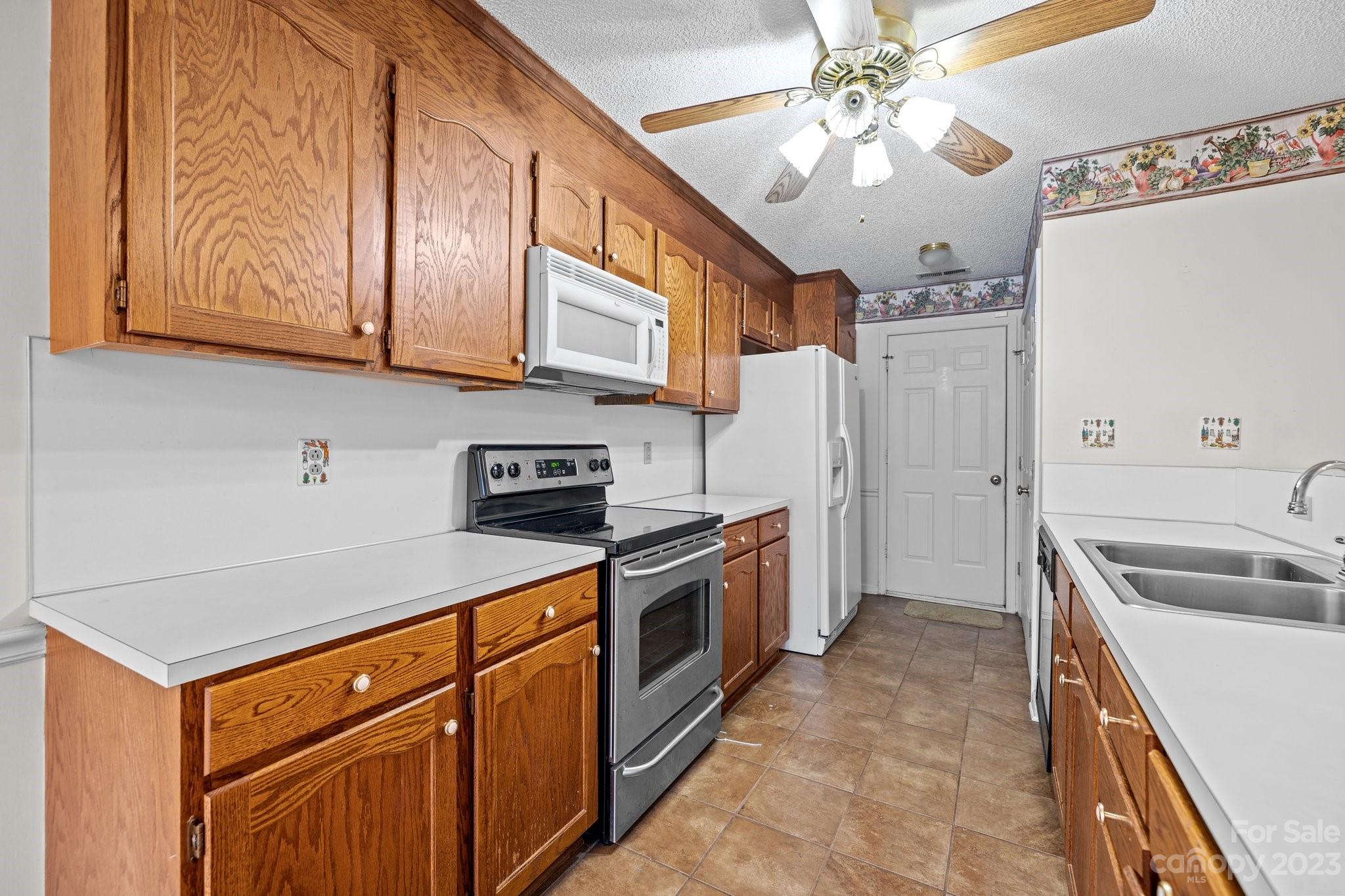 4445 Fawnbrook Avenue Southwest Concord, NC 28027 - Photo 8 of 27 a kitchen with stainless steel appliances granite countertop a sink stove and refrigerator