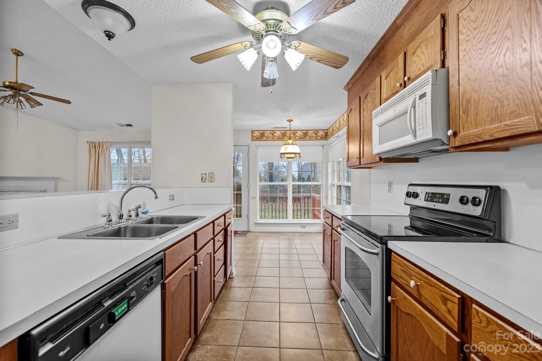 4445 Fawnbrook Avenue Southwest Concord, NC 28027 - Photo 10 of 27 a kitchen with stainless steel appliances granite countertop a sink stove and cabinets