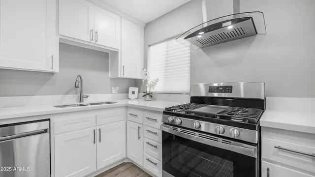 a view of a kitchen and a stove top oven