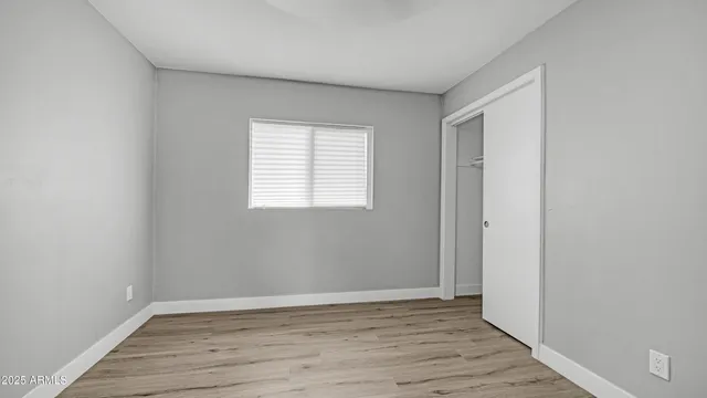 a bathroom with a granite countertop sink a toilet and a mirror
