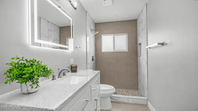 a bathroom with a shower toilet and sink