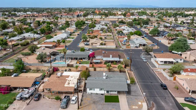 an aerial view of a house with a yard