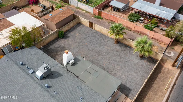 a front view of a house with a garden and trees