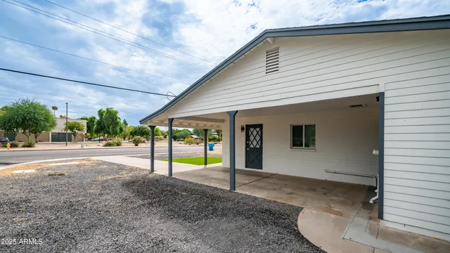 a view of a house with backyard and sitting area