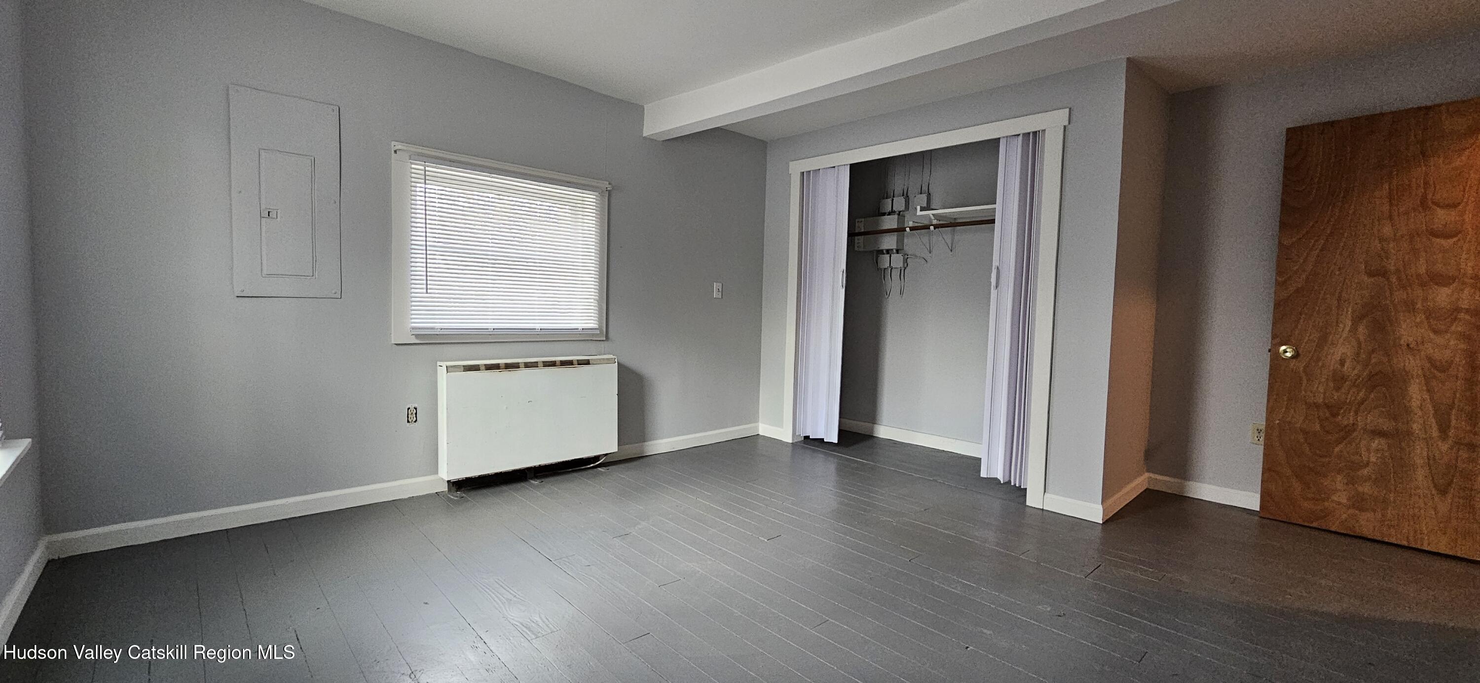 22 Spring Street Chatham, NY 12037 - Photo 12 of 61 an empty room with wooden floor and windows