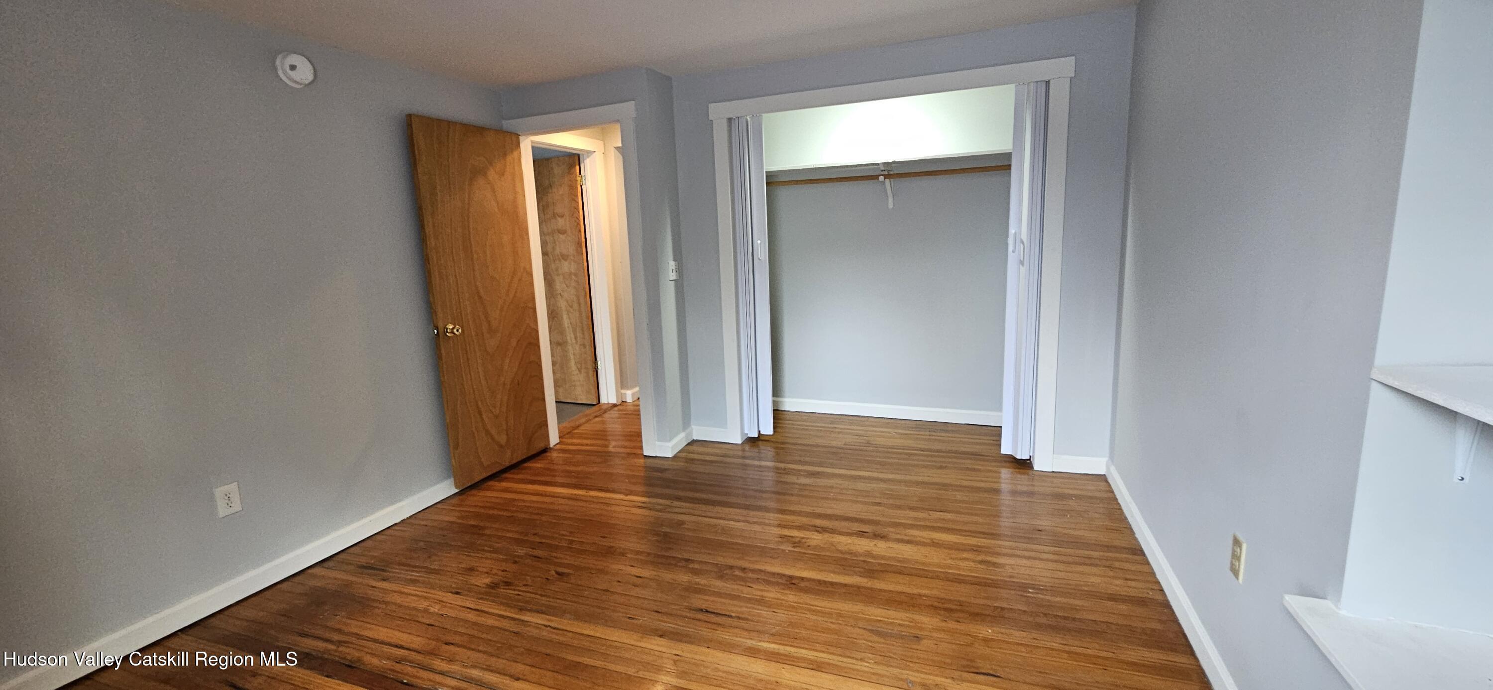 22 Spring Street Chatham, NY 12037 - Photo 14 of 61 a view of an empty room with wooden floor and a window