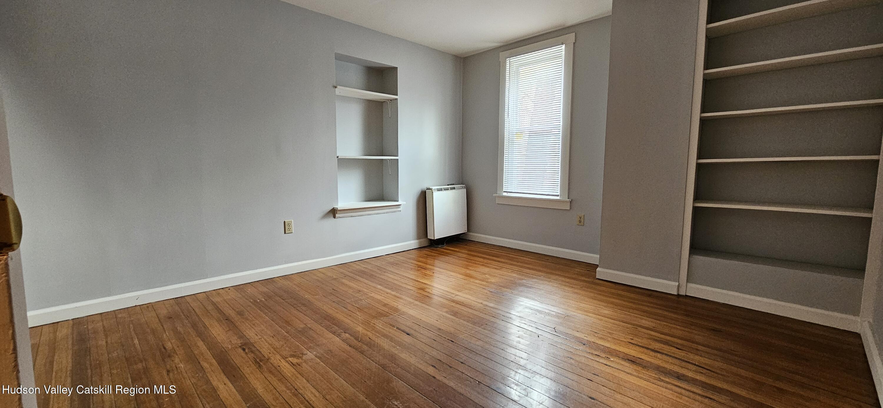 22 Spring Street Chatham, NY 12037 - Photo 15 of 61 a view of empty room with wooden floor and fan