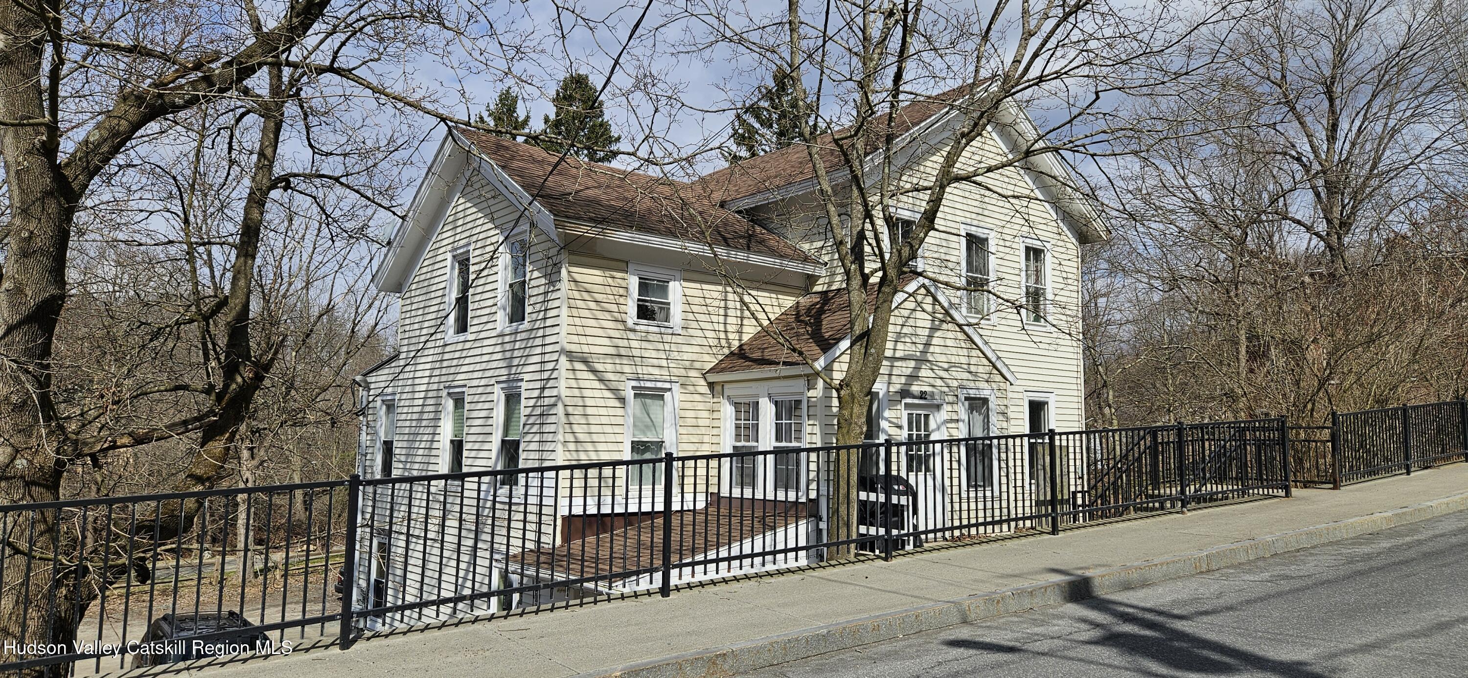 22 Spring Street Chatham, NY 12037 - Photo 2 of 61 a view of a brick house with large trees
