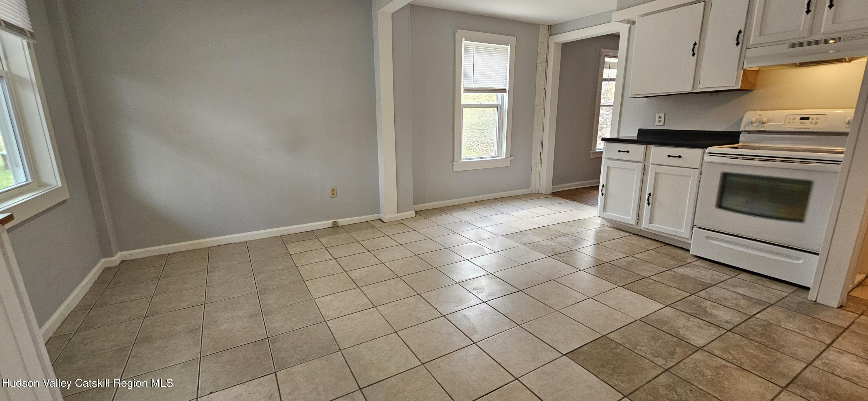 22 Spring Street Chatham, NY 12037 - Photo 21 of 61 a view of a kitchen with white cabinets and appliances