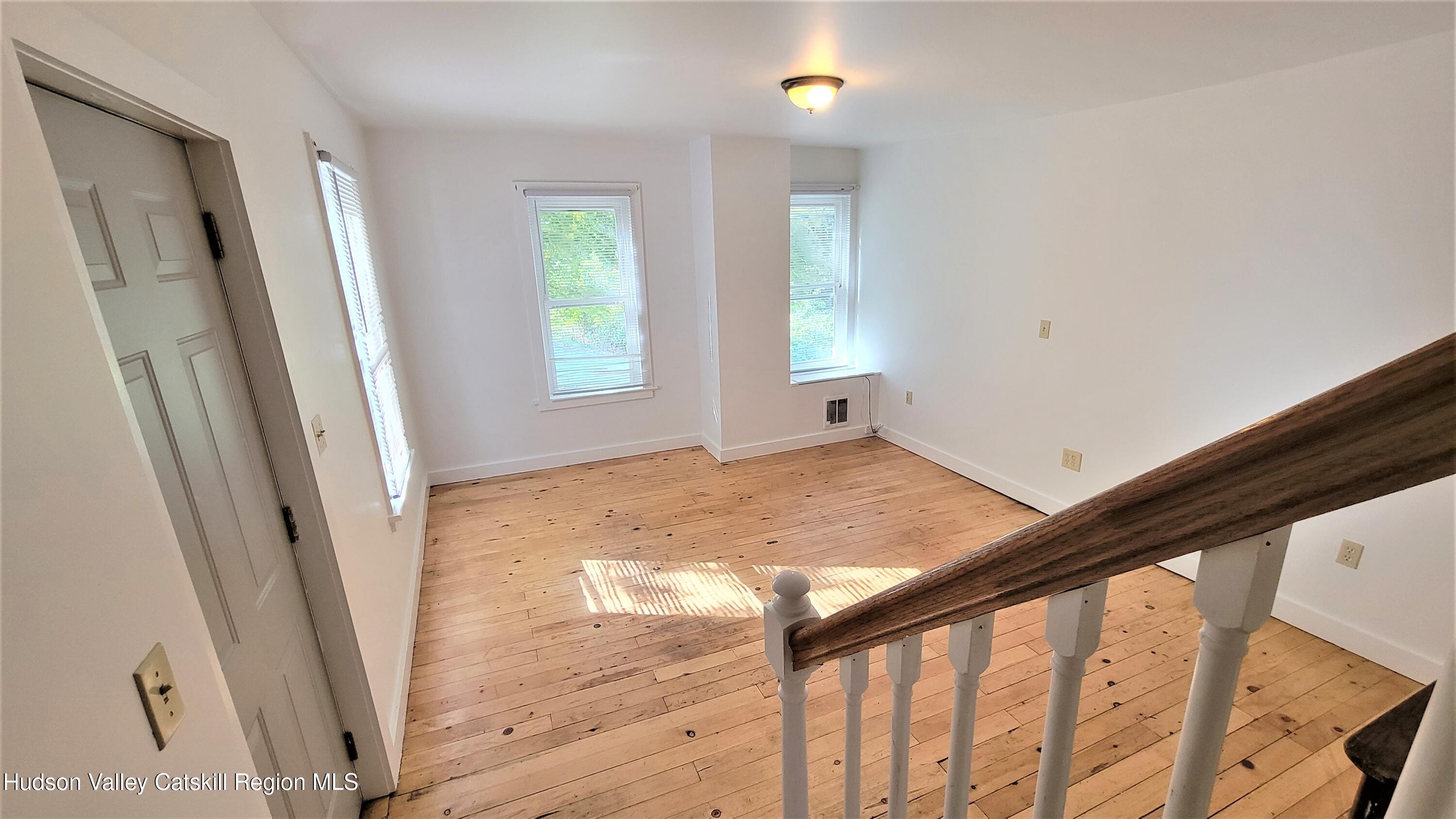 22 Spring Street Chatham, NY 12037 - Photo 32 of 61 a view of empty room with wooden floor and fan