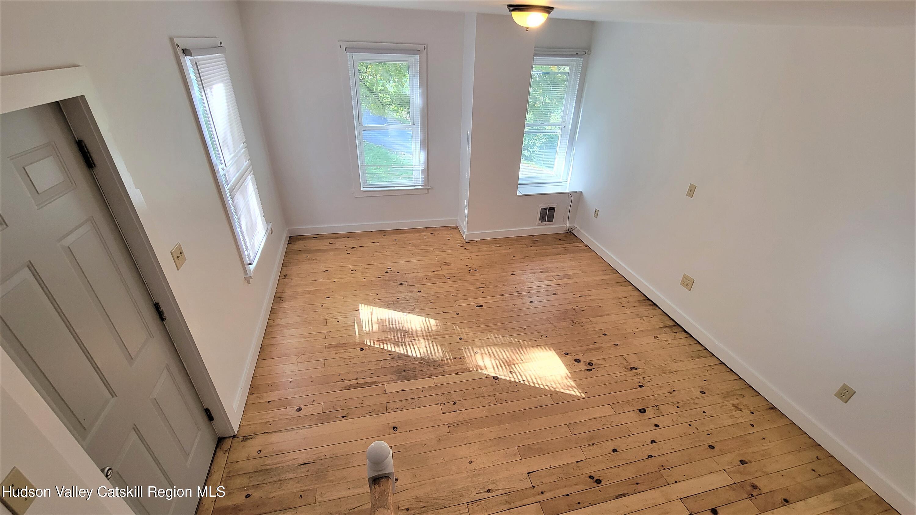 22 Spring Street Chatham, NY 12037 - Photo 46 of 61 wooden floor in an empty room with a window