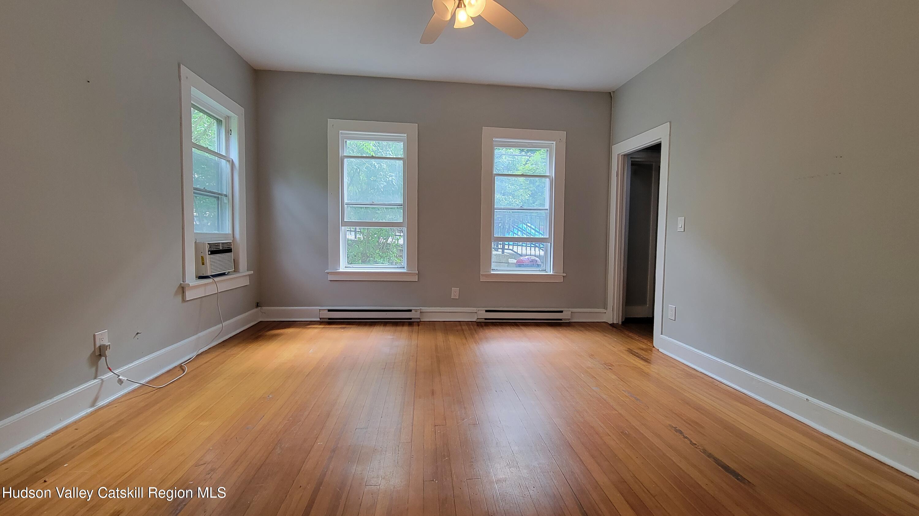 22 Spring Street Chatham, NY 12037 - Photo 48 of 61 an empty room with wooden floor and windows