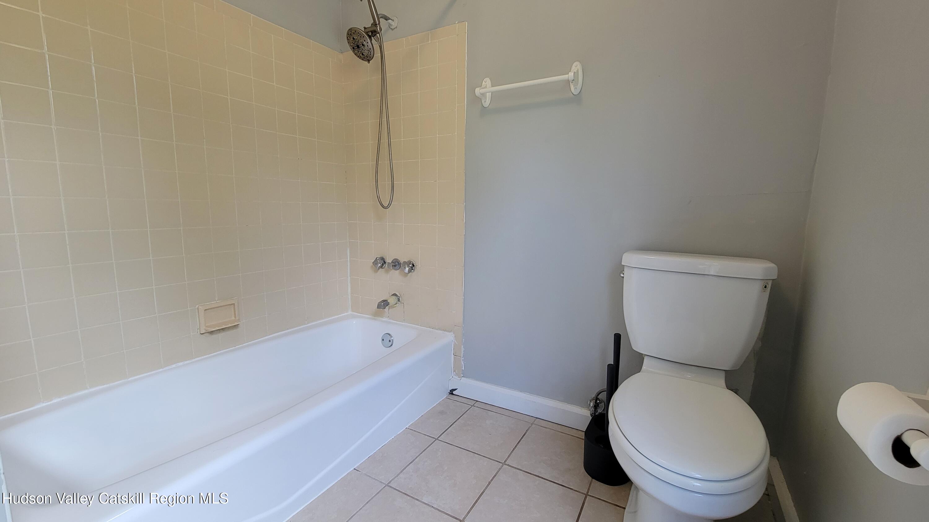 22 Spring Street Chatham, NY 12037 - Photo 50 of 61 a bathroom with a toilet and a bathtub