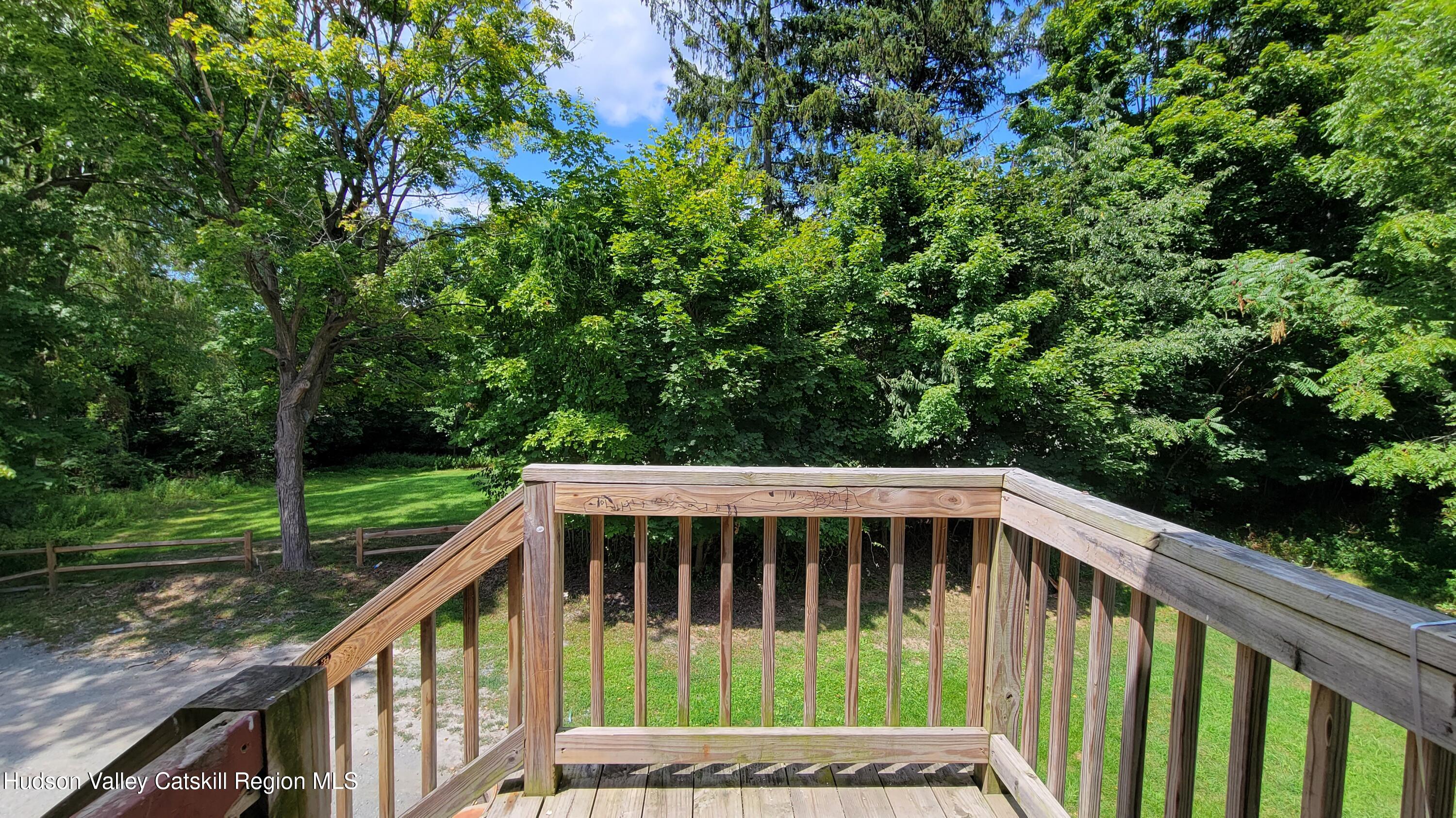 22 Spring Street Chatham, NY 12037 - Photo 5 of 61 a view of a small yard with wooden deck and floor