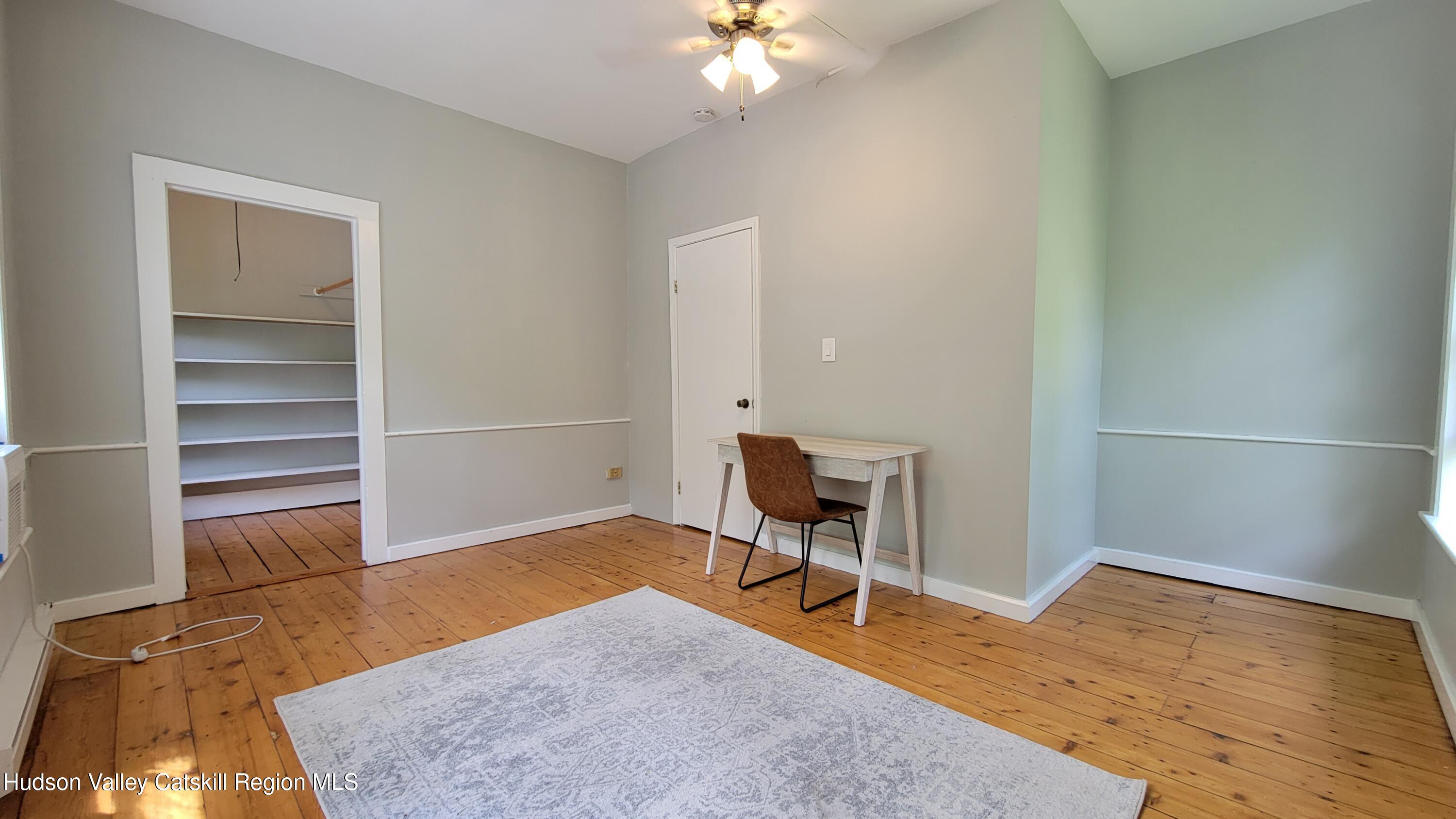 22 Spring Street Chatham, NY 12037 - Photo 54 of 61 a view of a livingroom with wooden floor and a workspace