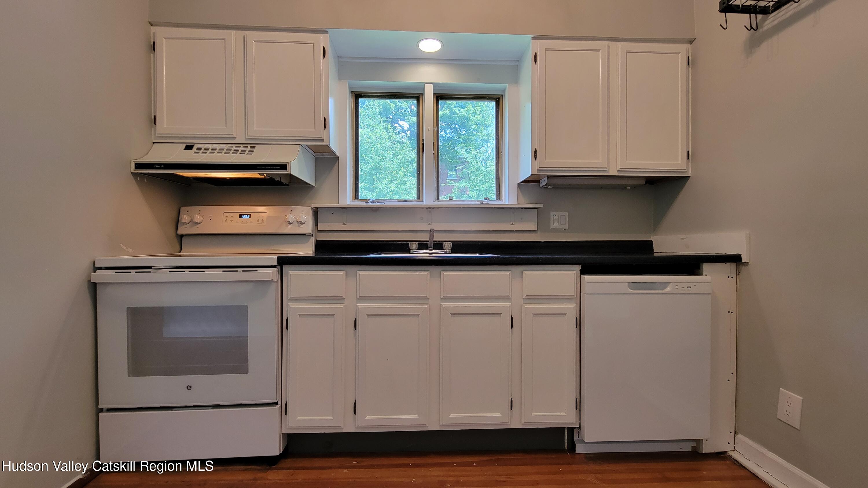22 Spring Street Chatham, NY 12037 - Photo 60 of 61 a kitchen with granite countertop white cabinets and a stove