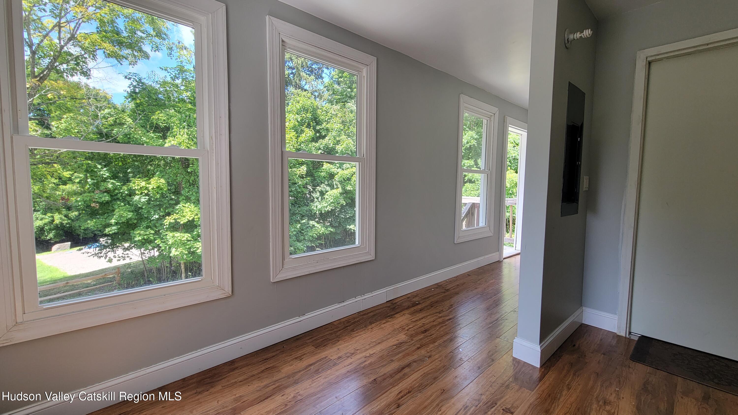 22 Spring Street Chatham, NY 12037 - Photo 61 of 61 a view of an empty room with wooden floor and a window