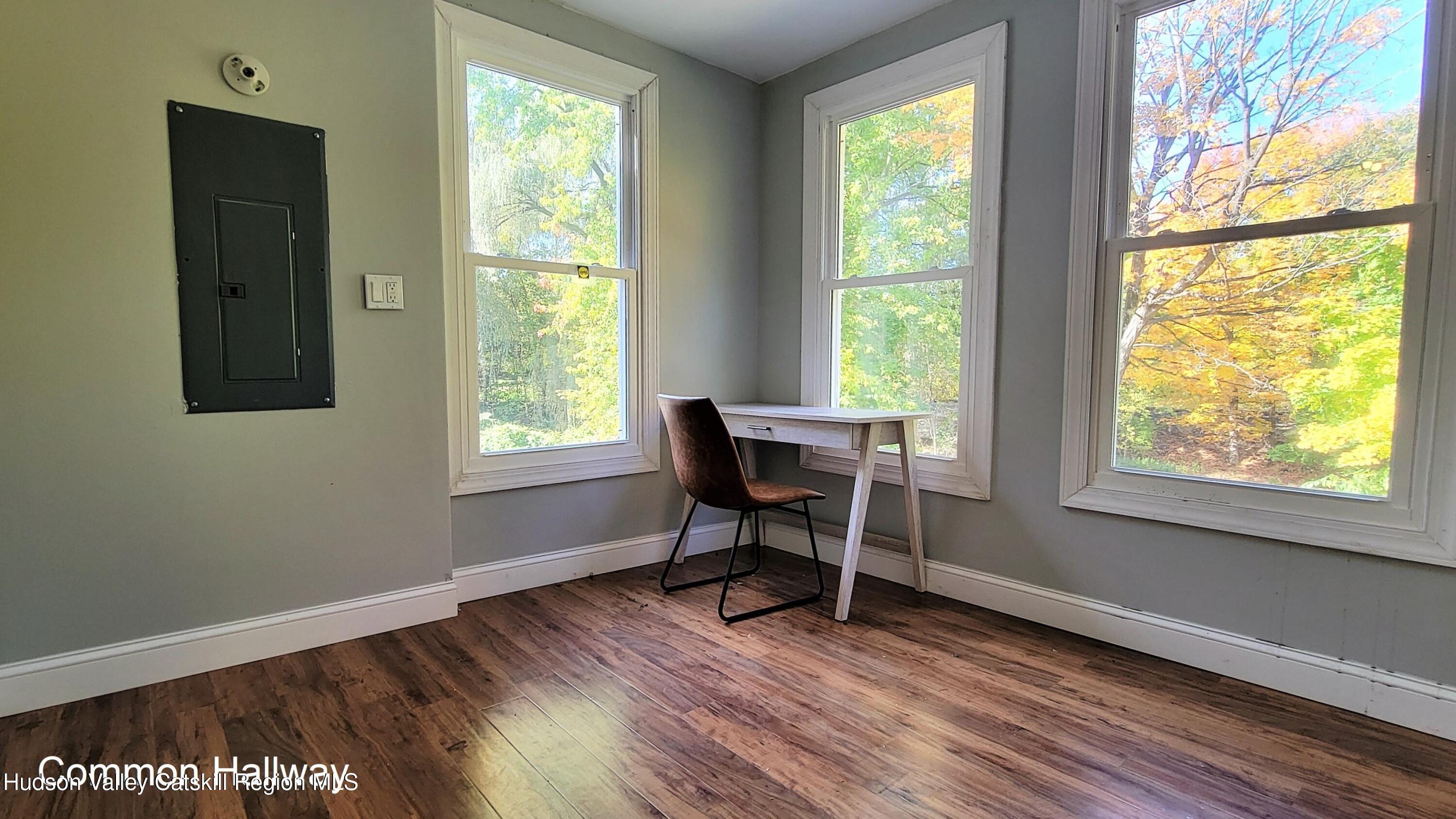 22 Spring Street Chatham, NY 12037 - Photo 7 of 61 a workspace with wooden floor and a window