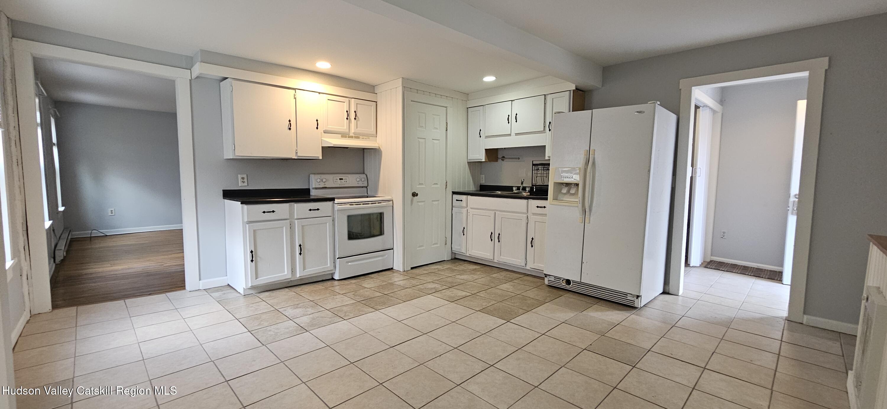 22 Spring Street Chatham, NY 12037 - Photo 8 of 61 a kitchen with a refrigerator sink and cabinets