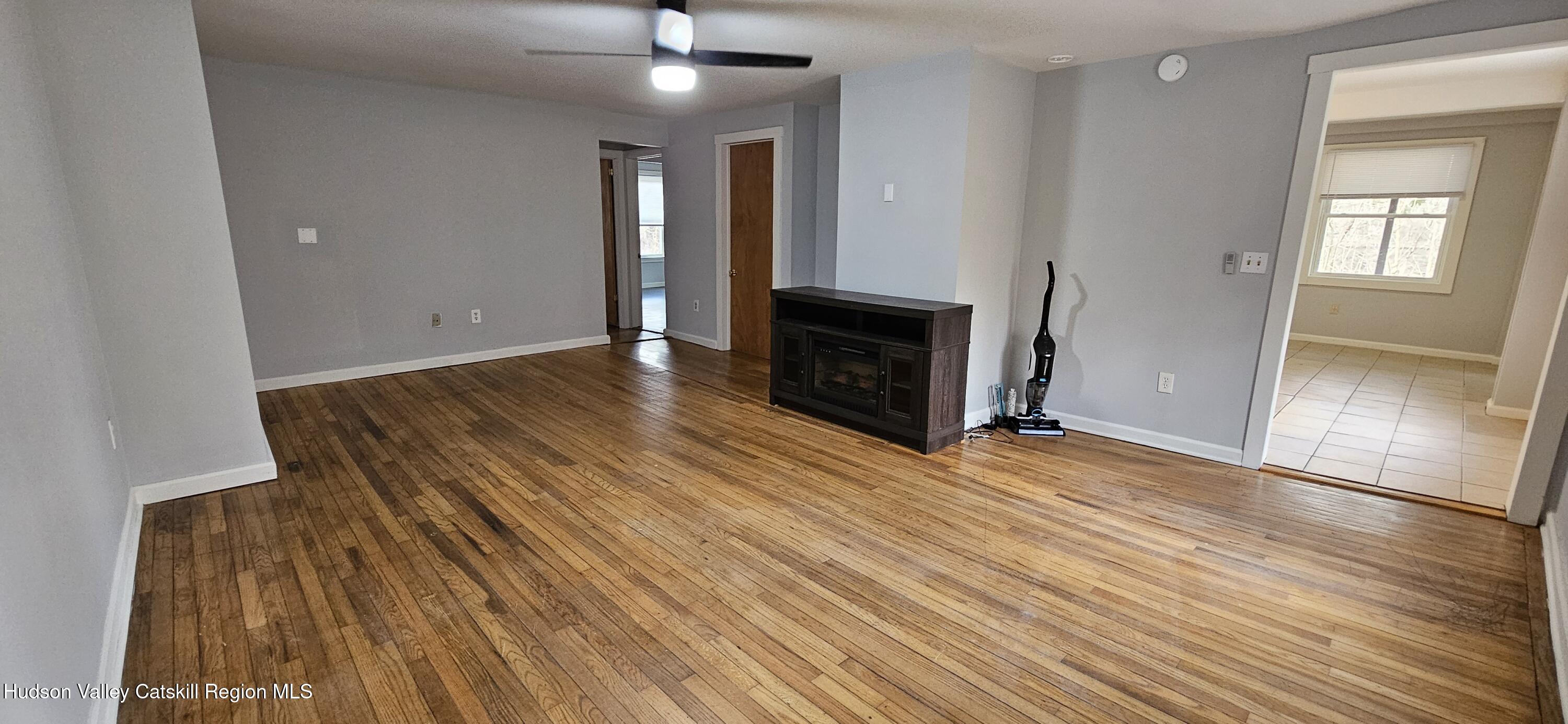 22 Spring Street Chatham, NY 12037 - Photo 9 of 61 wooden floor in an empty room with a fireplace