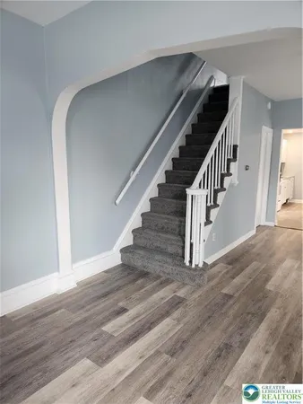 a view of entryway and hall with wooden floor