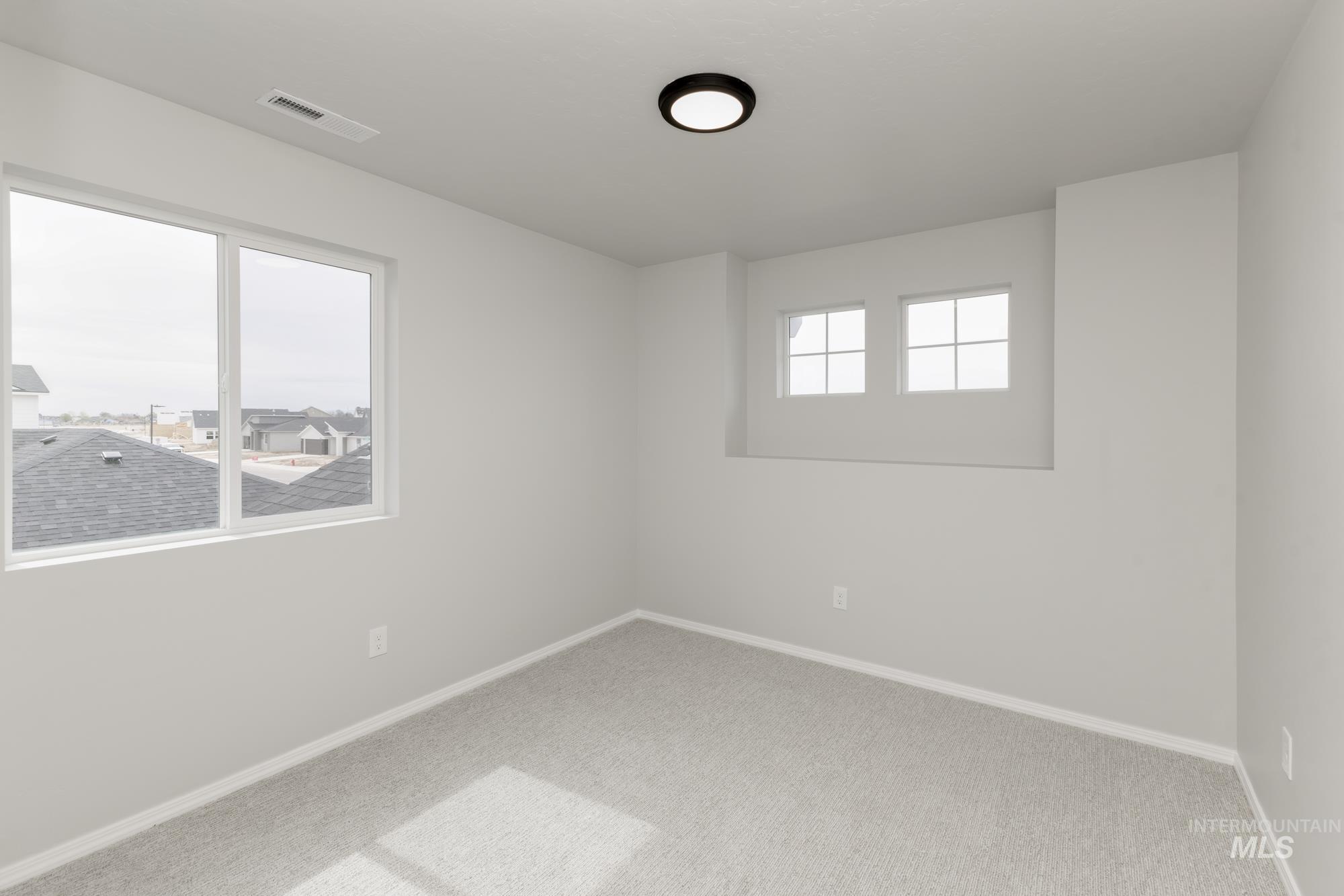 12842 Ropers Street Nampa, ID 83651 - Photo 18 of 29 Neutral-toned room featuring light gray carpet, white baseboards, and painted walls