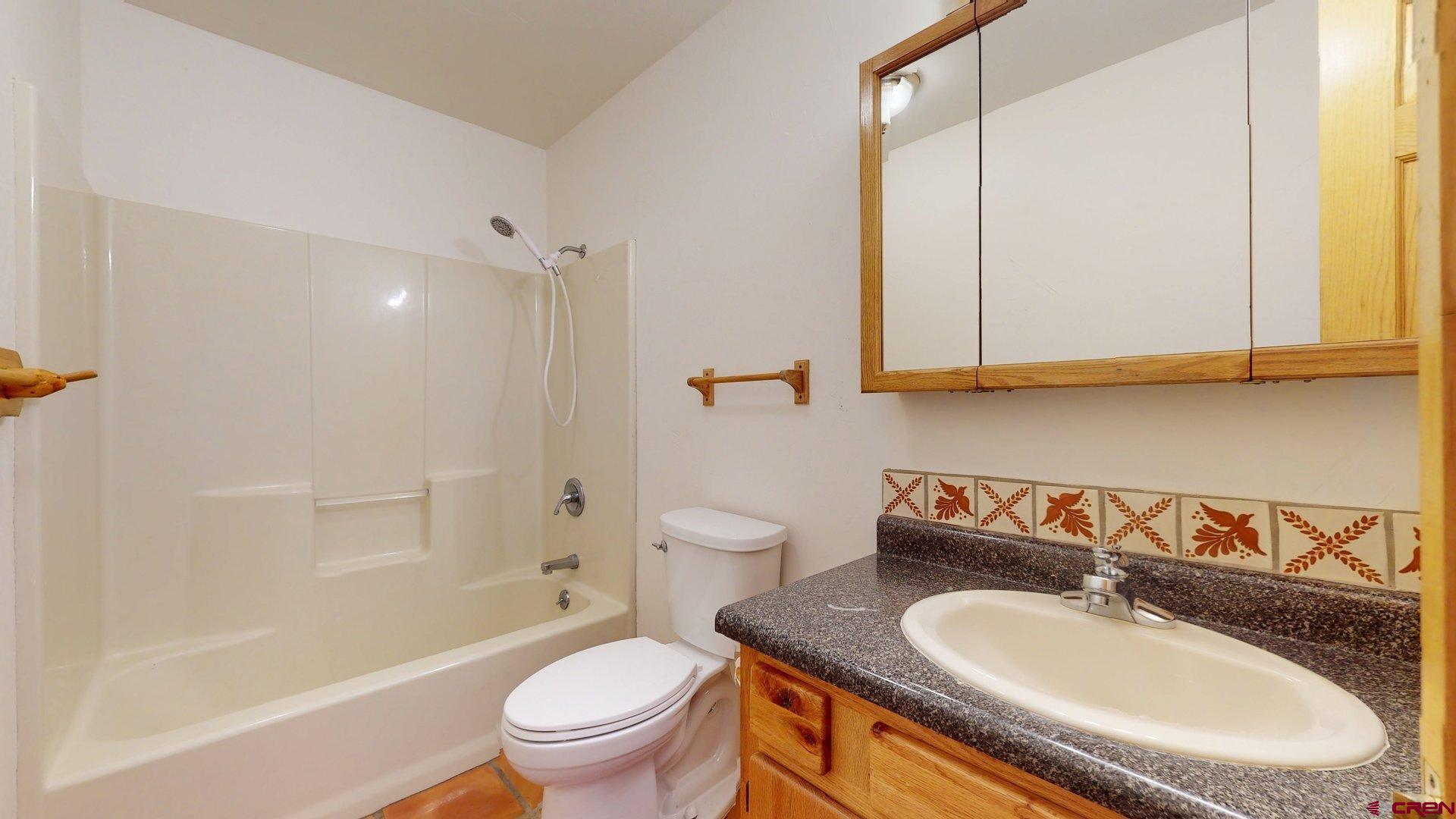40557 M75 Road Paonia, CO 81428 - Photo 15 of 34 a bathroom with a granite countertop sink toilet and shower
