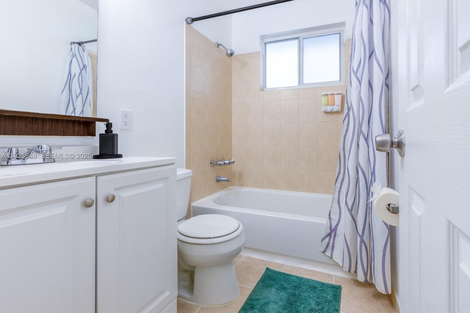 828 Southwest 2nd Street, Unit 2 Miami, FL 33130 - Photo 2 of 5 a bathroom with a sink a toilet and shower