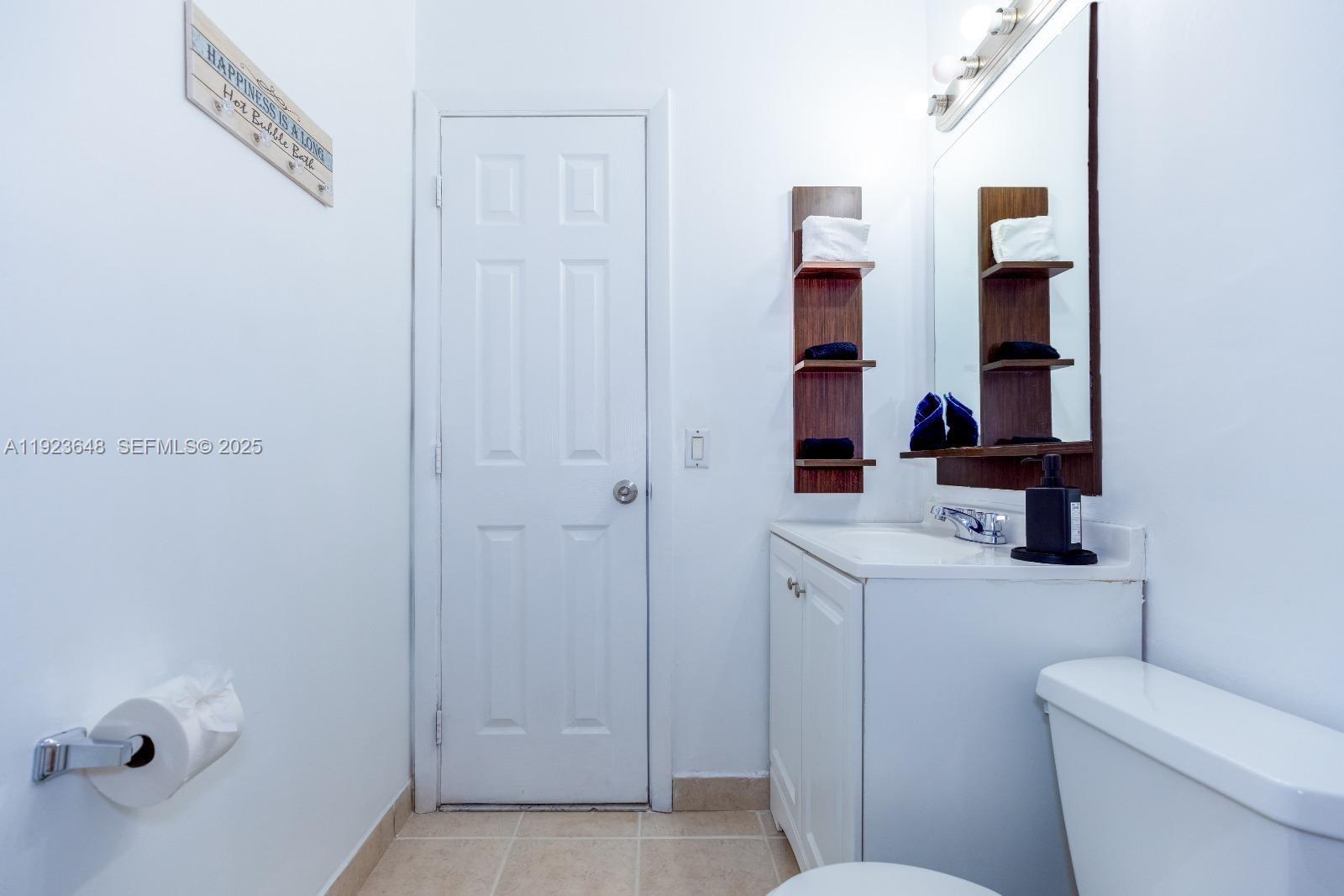828 Southwest 2nd Street, Unit 2 Miami, FL 33130 - Photo 3 of 5 a bathroom with a toilet and a sink