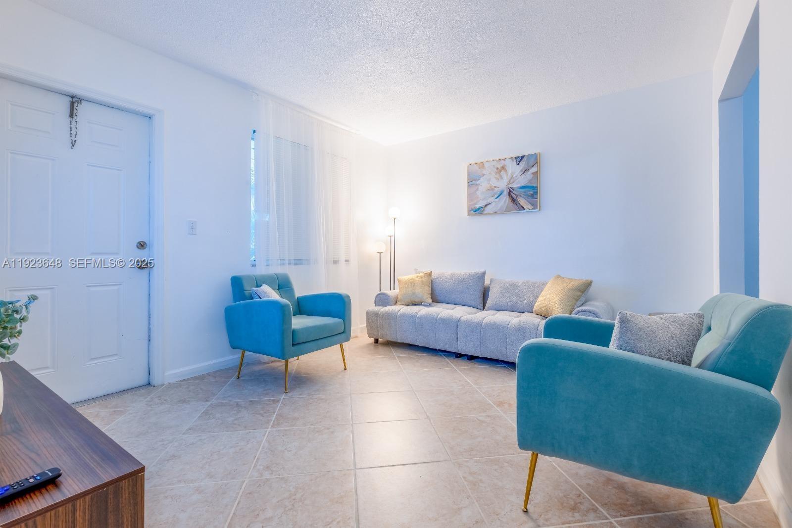 828 Southwest 2nd Street, Unit 2 Miami, FL 33130 - Photo 4 of 5 a living room with furniture a couch and a potted plant