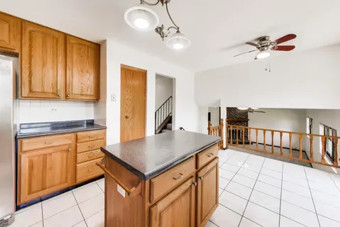 a kitchen with stainless steel appliances a sink cabinets and wooden floor