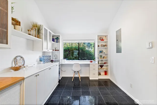 a kitchen with a sink cabinets and window