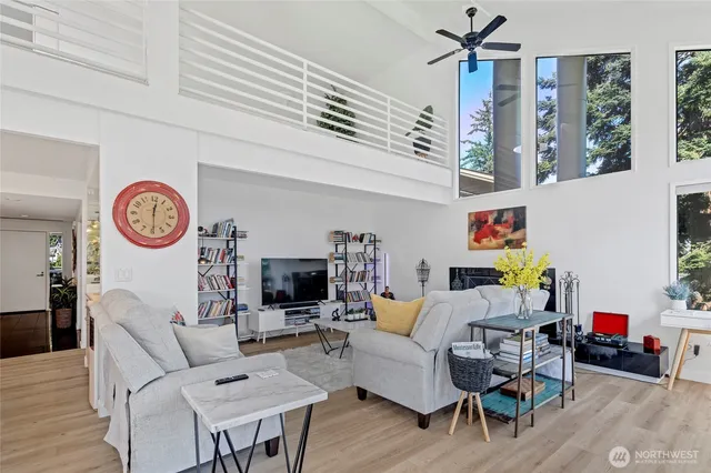 a living room with furniture a rug and a wall painting