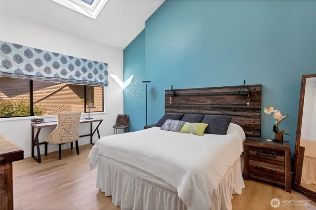 a bedroom with a bed and a chandelier