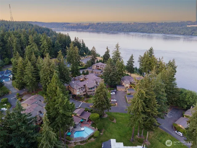 an aerial view of residential house with outdoor space and lake view