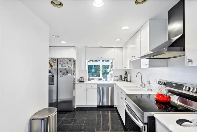 a kitchen with a sink cabinets and appliances