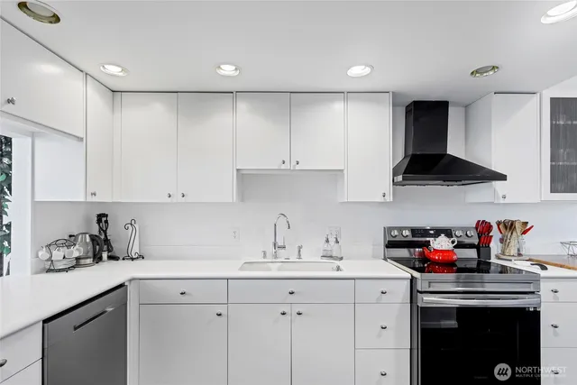 a kitchen with a sink stove and cabinets