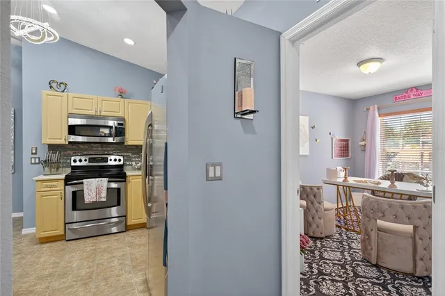 a kitchen with stainless steel appliances a stove a refrigerator sink and microwave