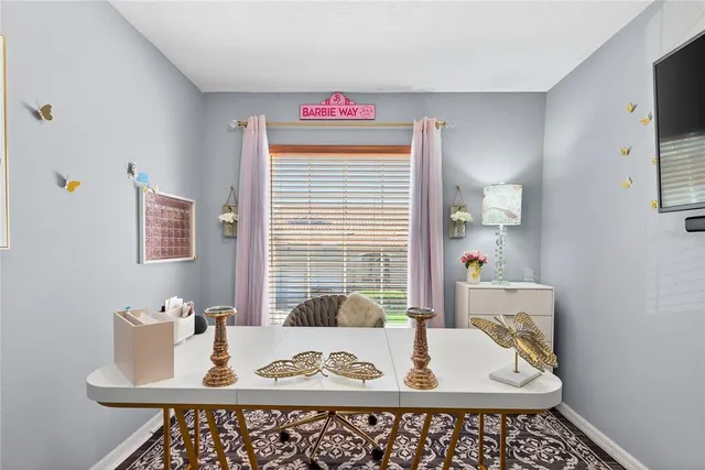 a view of a dining room with furniture and window