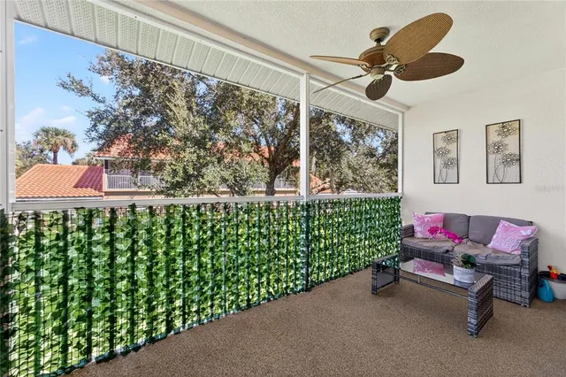 a view of a porch with furniture and garden