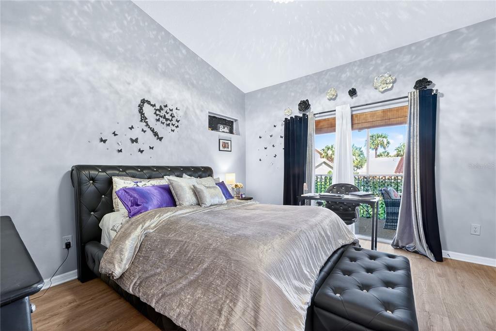 5336 Edgewater Way Oxford, FL 34484 - Photo 28 of 45 a bedroom with a bed and wooden floor