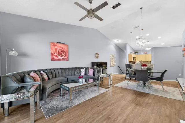 a living room with furniture and kitchen view