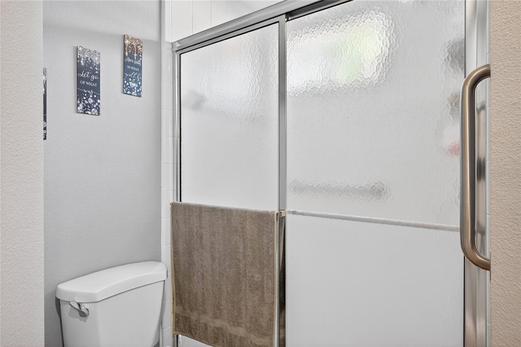 5336 Edgewater Way Oxford, FL 34484 - Photo 32 of 45 a bathroom with a shower and a toilet