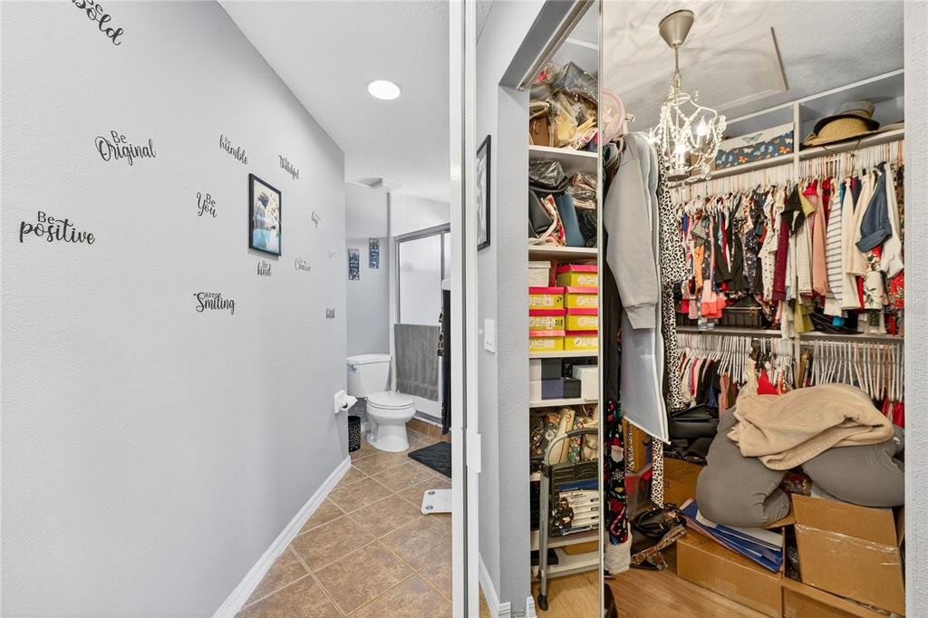 5336 Edgewater Way Oxford, FL 34484 - Photo 33 of 45 a view of walk in closet with clothes and shoes
