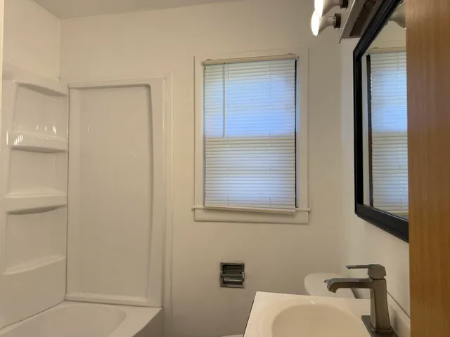 a bathroom with a toilet a sink and a shower
