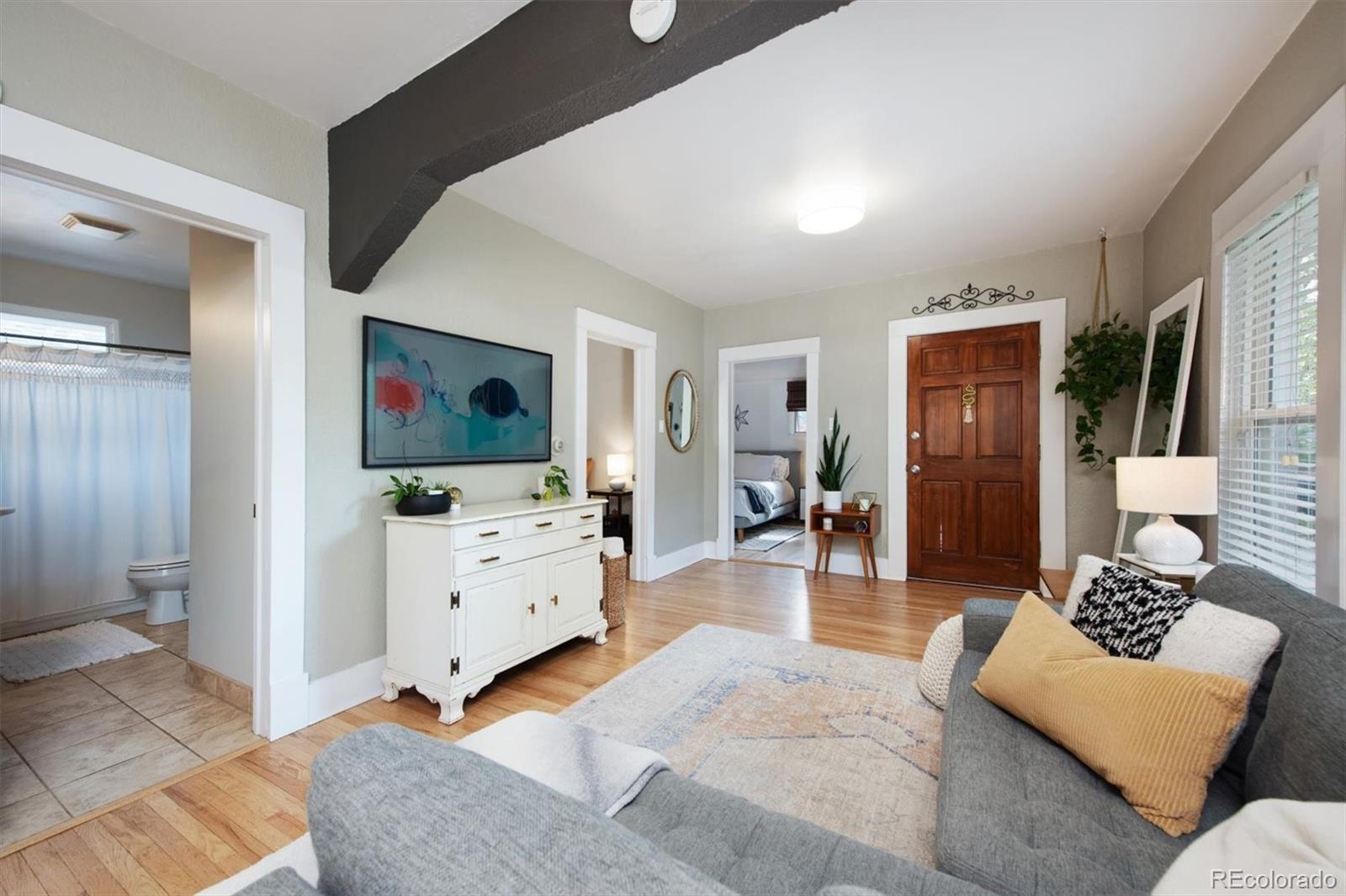 4335 Zenobia Street Denver, CO 80212 - Photo 2 of 26 a living room with furniture and a flat screen tv
