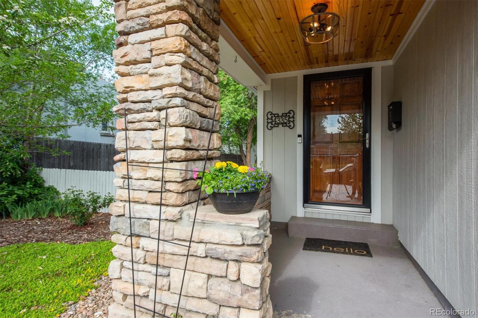 4335 Zenobia Street Denver, CO 80212 - Photo 24 of 26 a house with potted plants in front of door